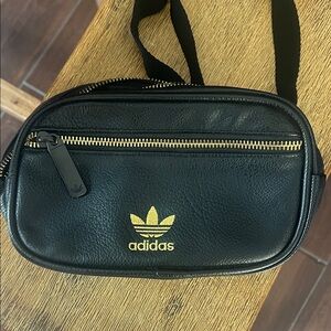 Adidas black faux leather w/gold stitched logo fanny pack. Measures about 8x5.
